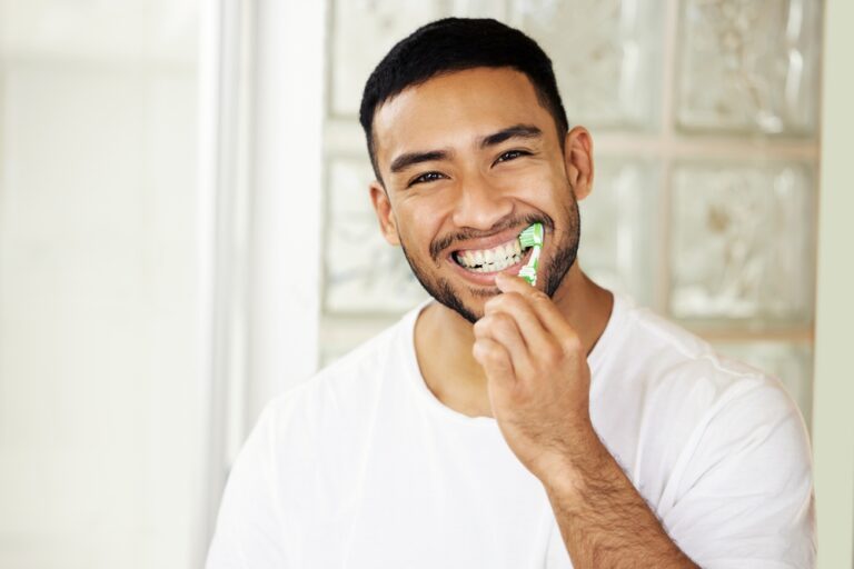 Man brushing his dental implants