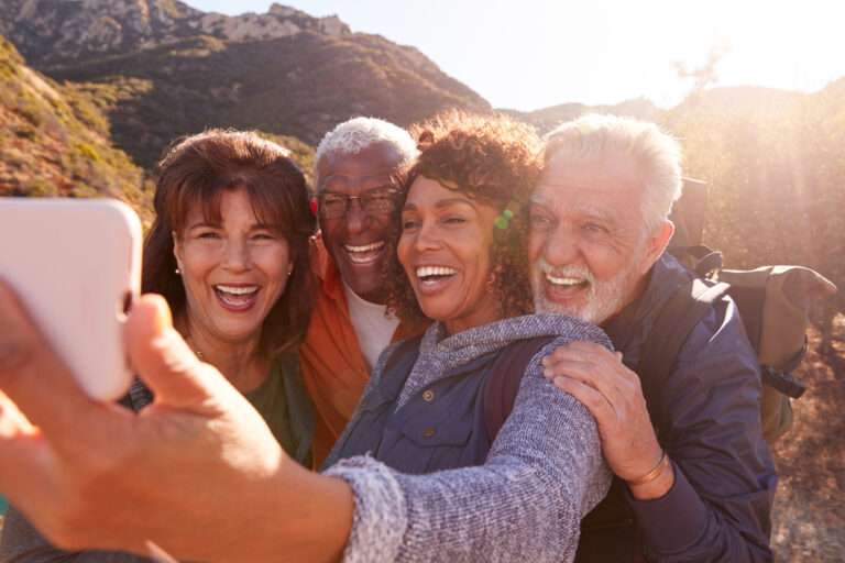 4 people with big smiles